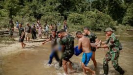 Satgas Pamtas RI Malaysia Yonarmed 11 Guntur Geni Kostras, mengevakuasi jasad Yulius, buruh PT BSI yang tewas tenggelam saat rekreasi ke Sungai Pasir Putih/Tonhap Siemanggaris,