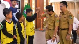 Bupati Nunukan, Irwan Sabri melakukan tos dengan anak sekolah saat membagikan seragam gratis secara simbolis yang menjadi implementasi salah satu program unggulan Pemerintah, Selasa (26/8/2025).