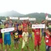 Sekawanan bocah perbatasan RI - Malaysia membentangkan kertas bertulisan 'I Love Lumbis Hulu'. Di Kecamatan ini, terdapat 3 Desa yang dinyatakan BNPP masuk wilayah Malaysia pasca penyelesaian OBP. Masing masing, Desa Kabugalor, Desa Lipaga dan Desa Tetagas. Dok.Medsos Lumbis Hulu.