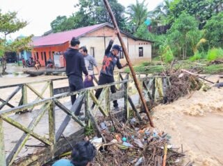 Petugas BPBD Nunukan sedang menyingkirkan sampah di salah satu jembatan kayu agar aliran air bisa lancar. Dok.BPBD Nunukan.